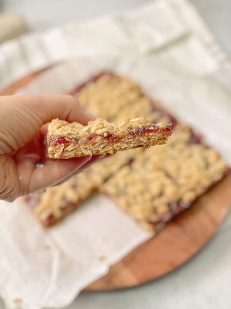These homemade protein jam bars are made of a wholesome mixture of flour, oats, brown sugar, coconut oil, syrup, and your favorite flavor of jam.