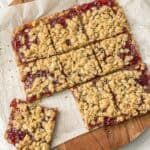 homemade protein jam bars cut into small equal squares on parchment paper