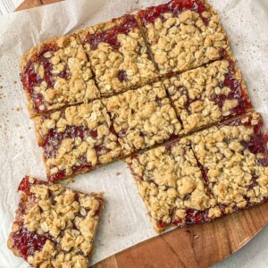 homemade protein jam bars cut into small equal squares on parchment paper