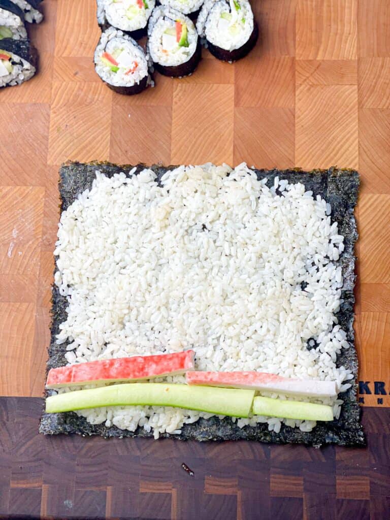 Nori Seaweed topped with sushi rice, cucumber slices and imitation crab