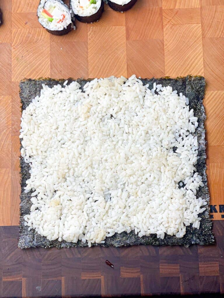 Nori seaweed topped with white sushi rice