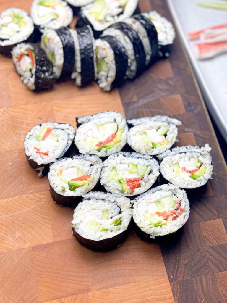Delicious Japanese sushi rolls filled with rice, imitation crab, shrimp, and cucumber.