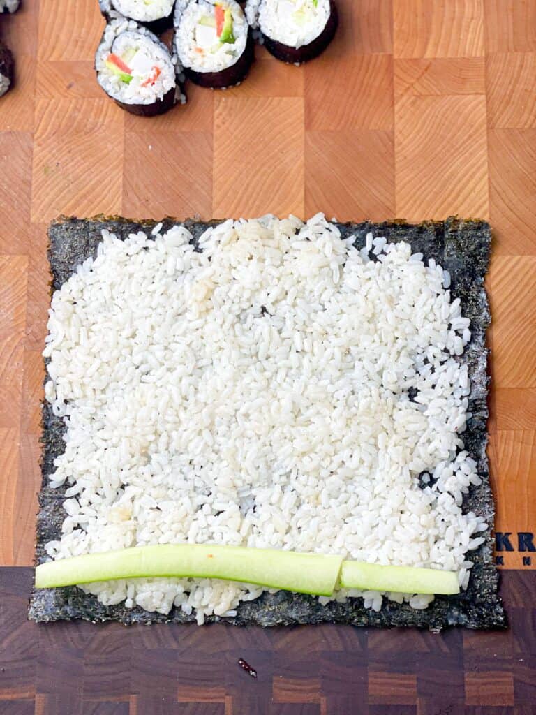 Nori Seaweed topped with sushi rice and cucumber slices