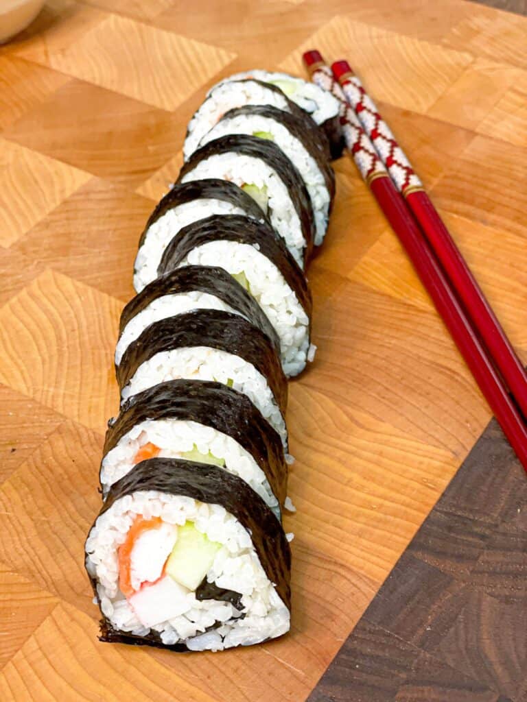 Slices of similar sized sushi rolls ready to be served