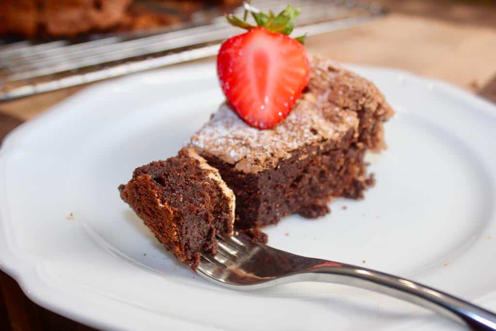 A bite of chocolate fudge cake suitable for gluten-free diet