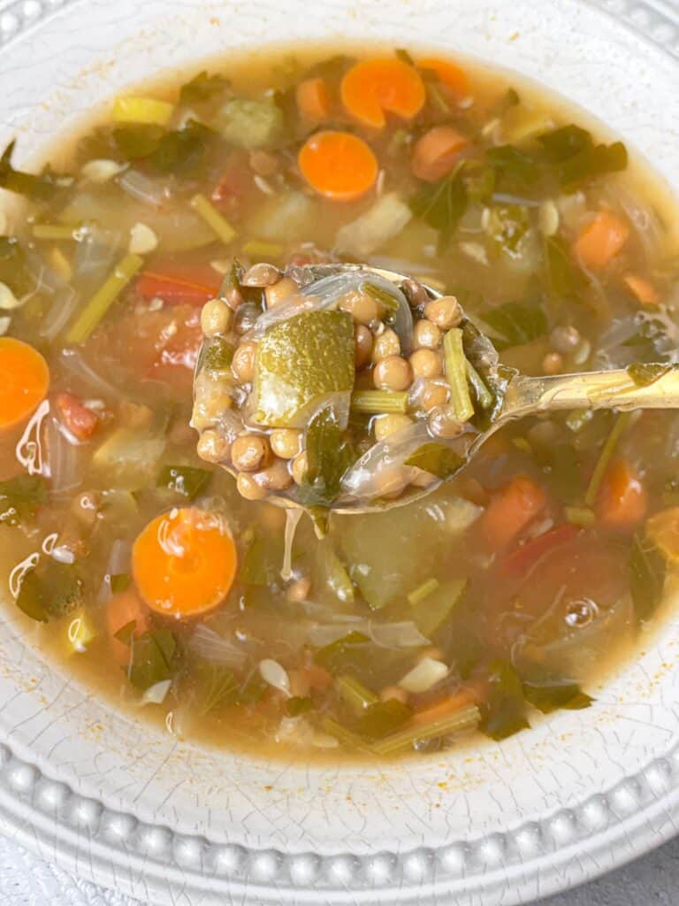Enjoy a hearty bowl of lentil and squash soup with some carrots and tomatoes.