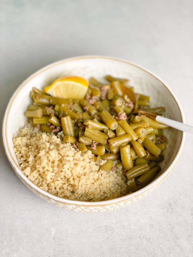 Green bean stew with quinoa soaking in the delicious sauce.