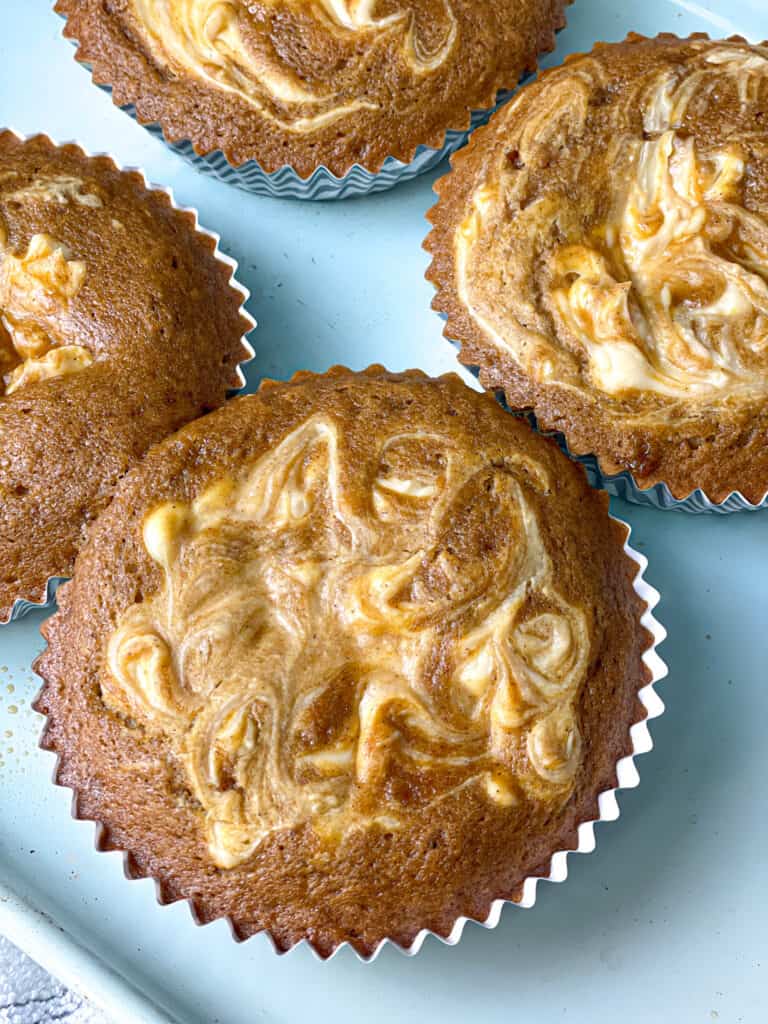 Glorious pumpkin muffins topped with thick swirls of sweet cream cheese that melt right into the top as they bake. 