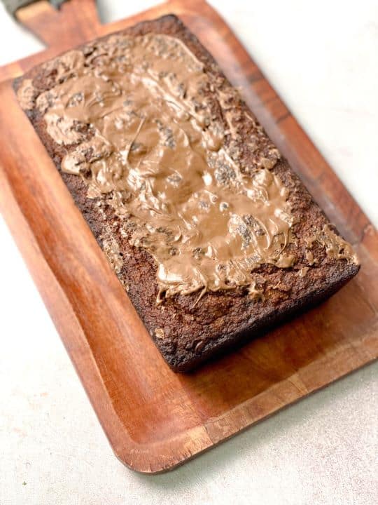 A soft and fluffy cake made of almond flour, mashed bananas, and other healthy ingredients. This cake is baked in a rectangular pan and can be coated with melted chocolate.