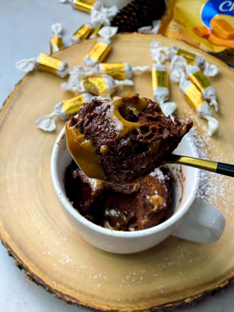 A portion of chocolate caramel mug cake with extra caramel sauce is so moist and delicious.