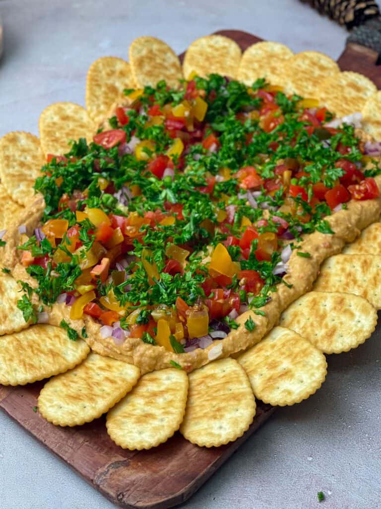 A beautiful platter of hummus, veggies, and crackers
