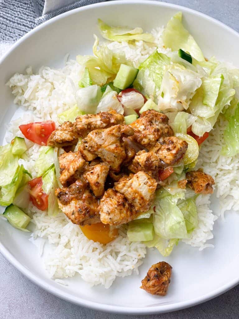 Juicy tender chicken shish tawook on top of salad and rice is an amazingly healthy.