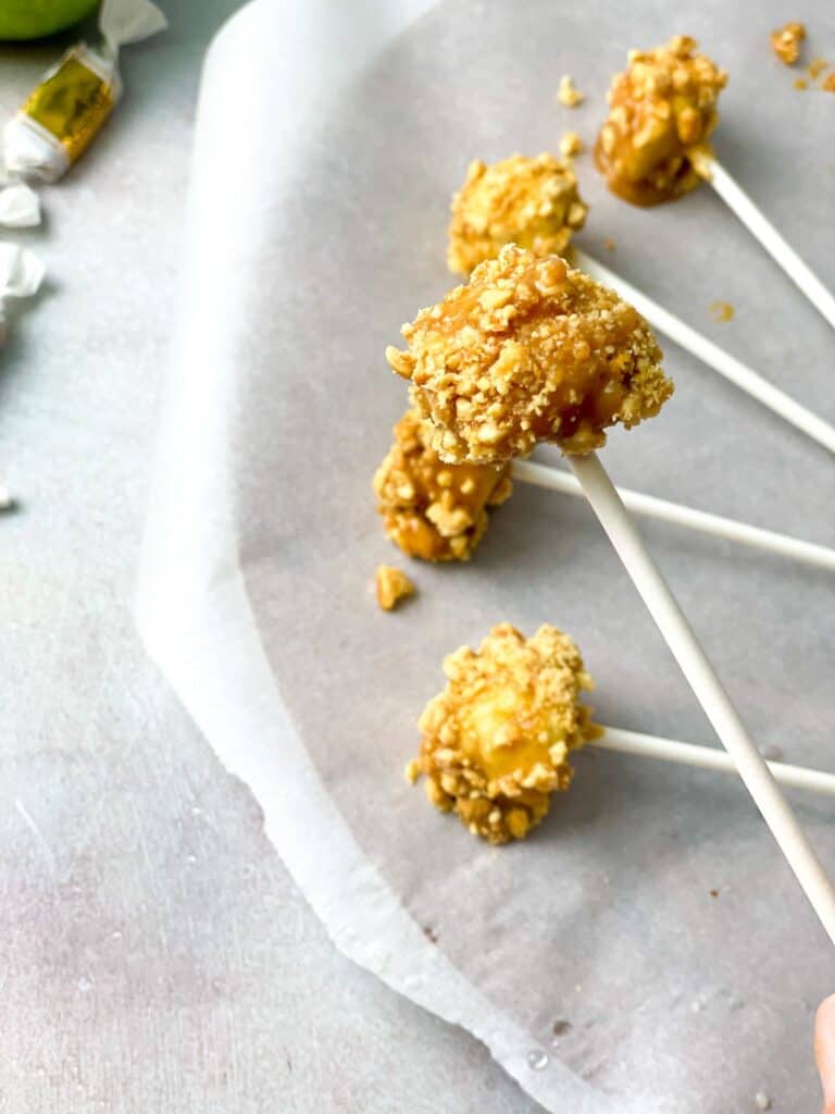 Mini apple bites dipped in melted caramel and your favorite toppings and inserted into lollipop sticks. 
