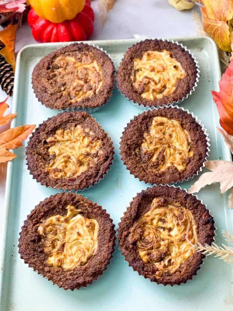 6 gluten-free cheese cake pumpkin muffin swirls in a baking tray