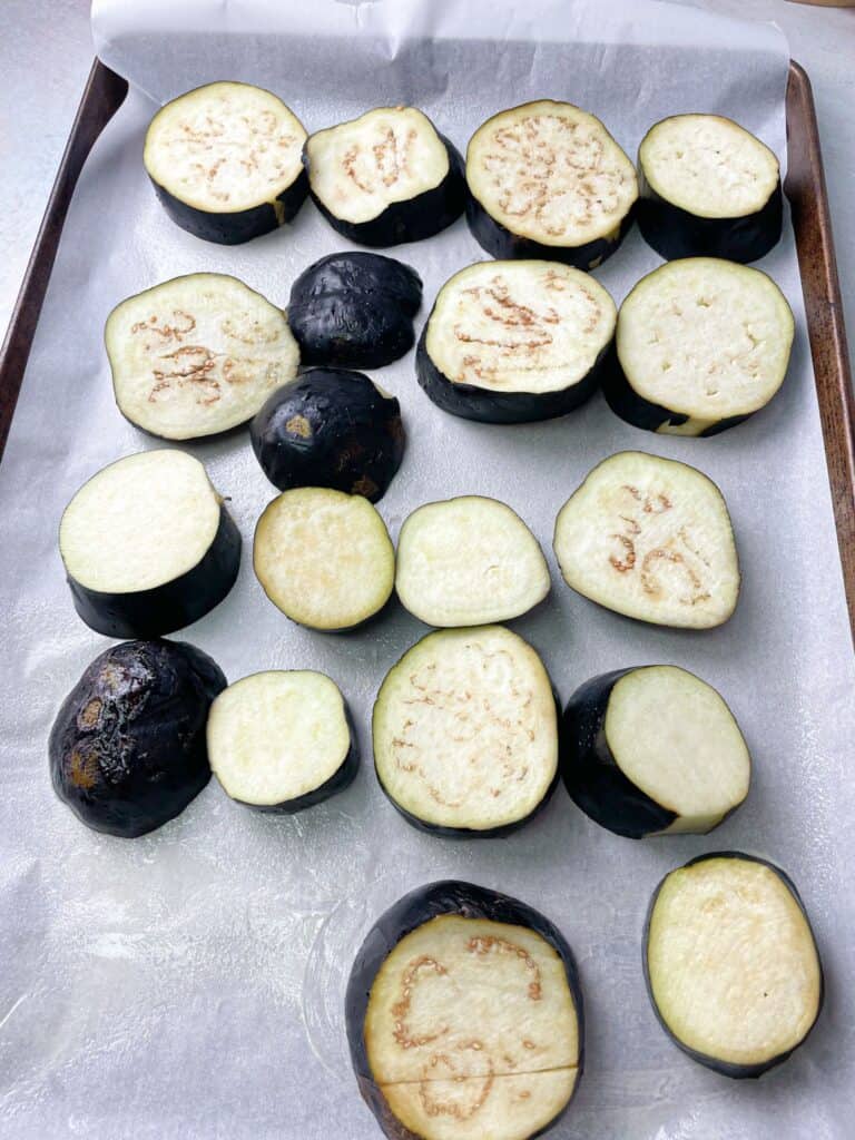 eggplants cut into slices and placed on a baking sheet in the oven