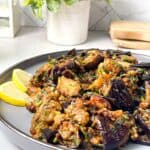 Eggplant with Cilantro a spicy recipe in a plate with a slice of lemon that makes flavors reach perfection!
