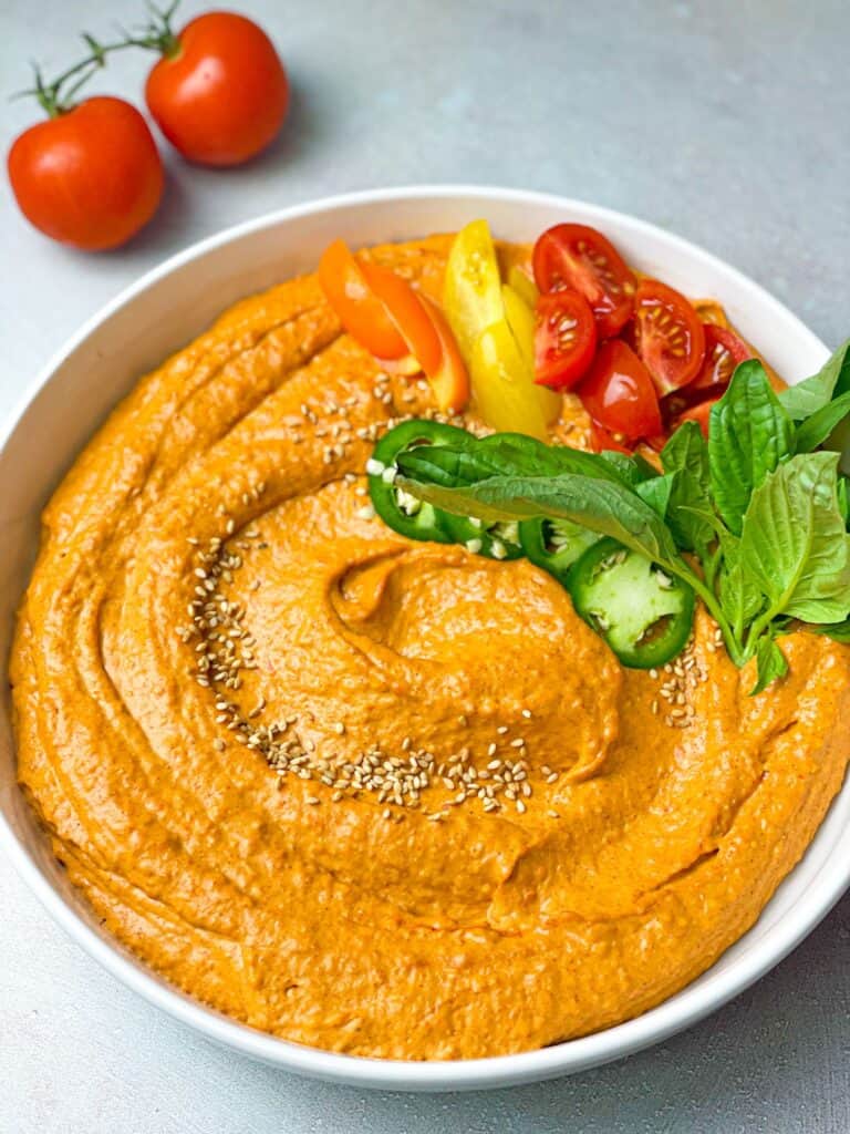 A flavorful homemade hummus dip filled with roasted red peppers and spicy cayenne pepper. 