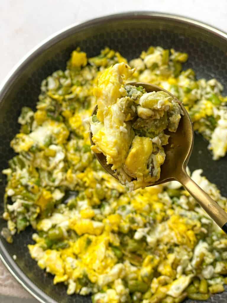 a spoon of the hearty eggs and asparagus skillet 