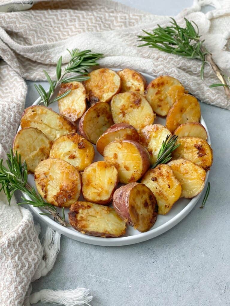 a plate of baby potatoes cut in half and baked in the oven with seasoning 