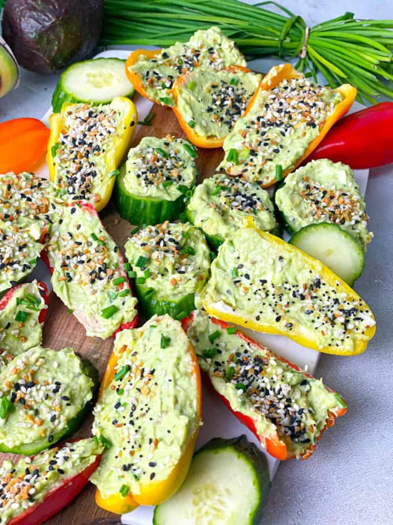 Avocado Cream Cheese Veggie Bites layered on a wooden board and ready to be served