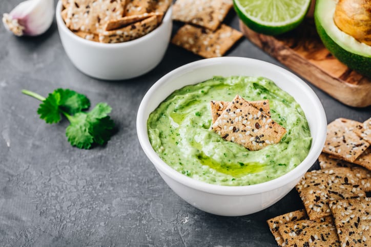 A bowl full of vibrant green avocado ranch dipping sauce. This delicious dip is perfect for all occasions