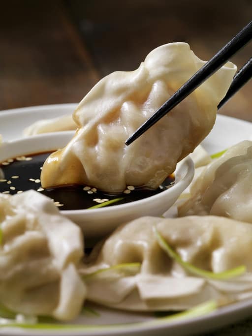 cooked dumplings dipped into a perfect dumpling dipping sauce