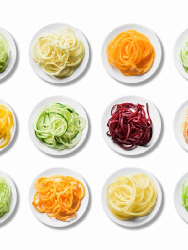brightly colored healthy pastas in small round white plates