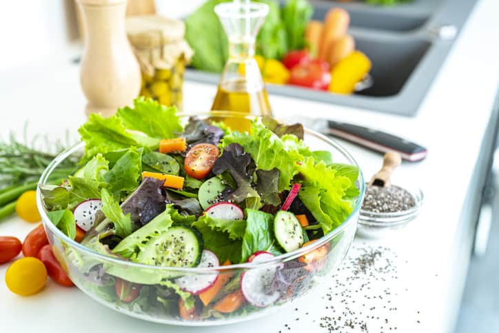 Healthy eating and vegetarian food: close up view of a fresh healthy salad bowl shot on kitchen counter. 