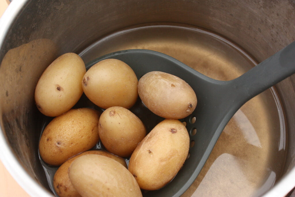 A bunch of golden potatoes after being boiled in water 