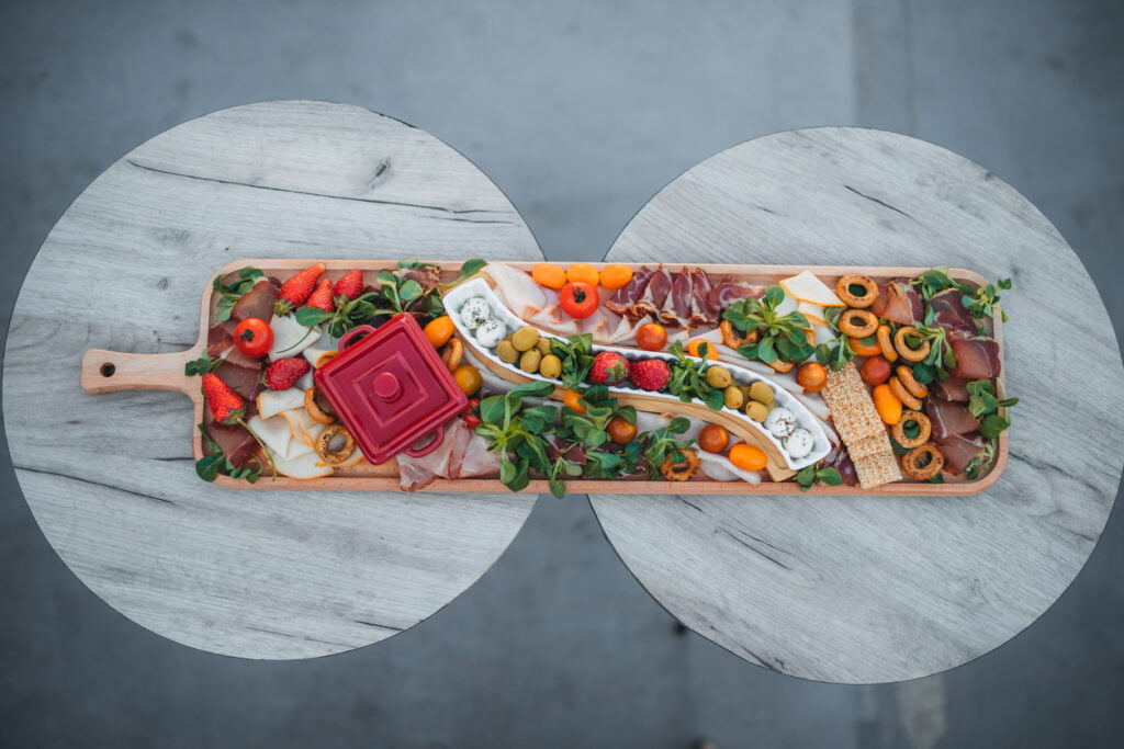 Everything You Need On One Board, literally!  This board has a selection of meats, cheese, produce and crackers, all in one. 
