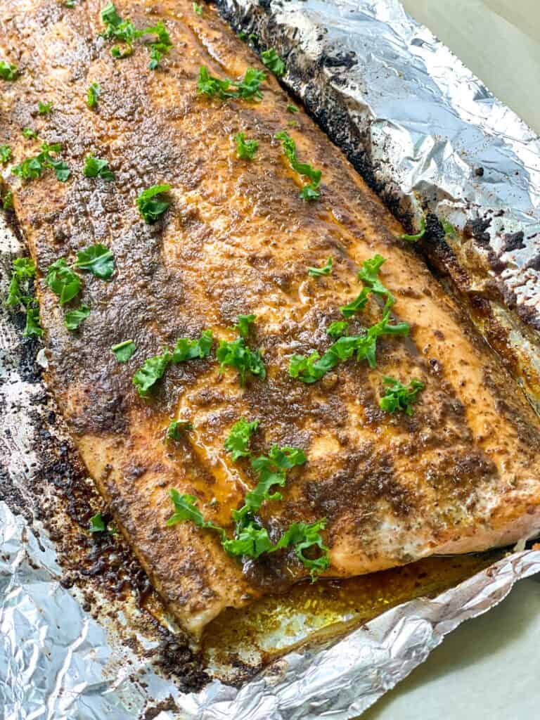 Perfectly flaky and juicy oven baked salmon garnished with parsley