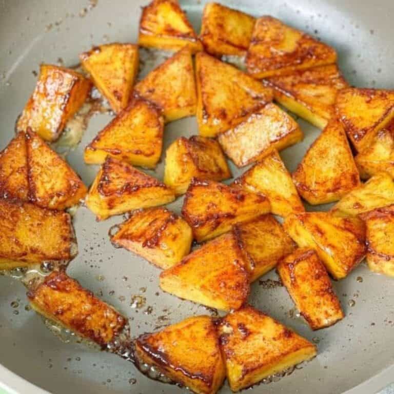 Grilled pineapple pieces have a brown crust because they are caramelized with butter, honey, and cinnamon.