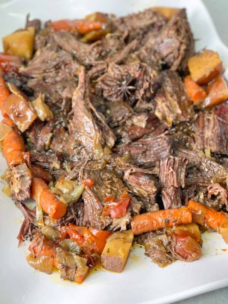 This tender beef recipe presents a mix of well-seasoned meat, vegetables, and rich gravy