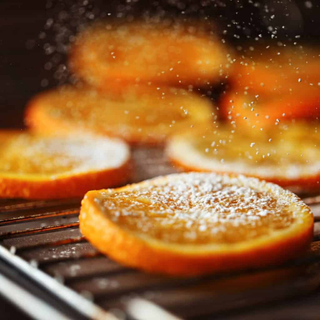 Delicious seasoned orange slices placed in the oven.