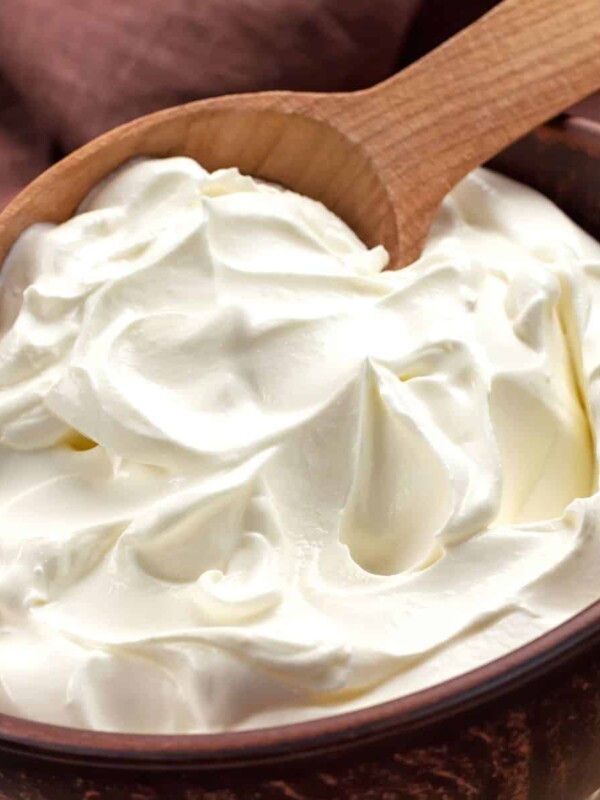 a bowl of homemade cream cheese with a wooden spoon