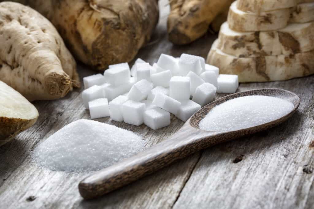 A spoonful of white sugar and some sugar cubes