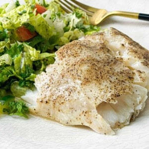 white, flaky, and tender corvina fillet served with salad