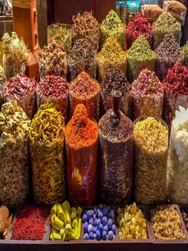 A group of different spices displayed in bags in a on old traditional market