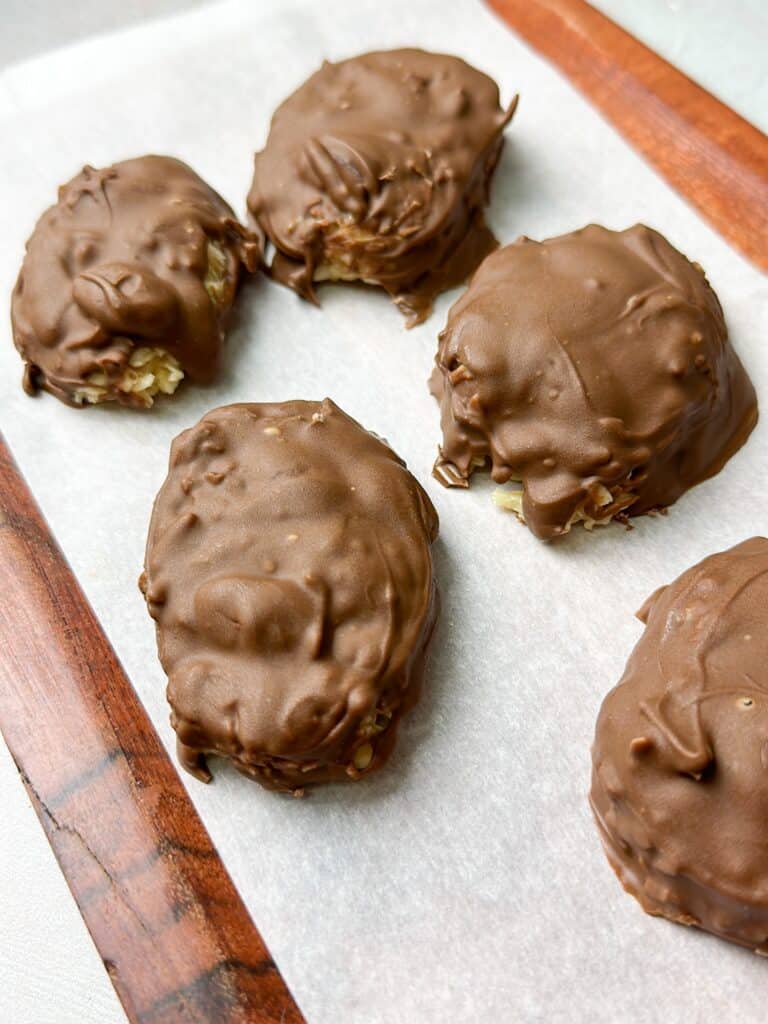 5 coconut and chocolate bars on parchment paper