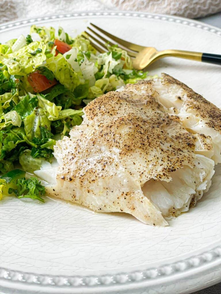 tender and flaky corvina fish filet served with salad