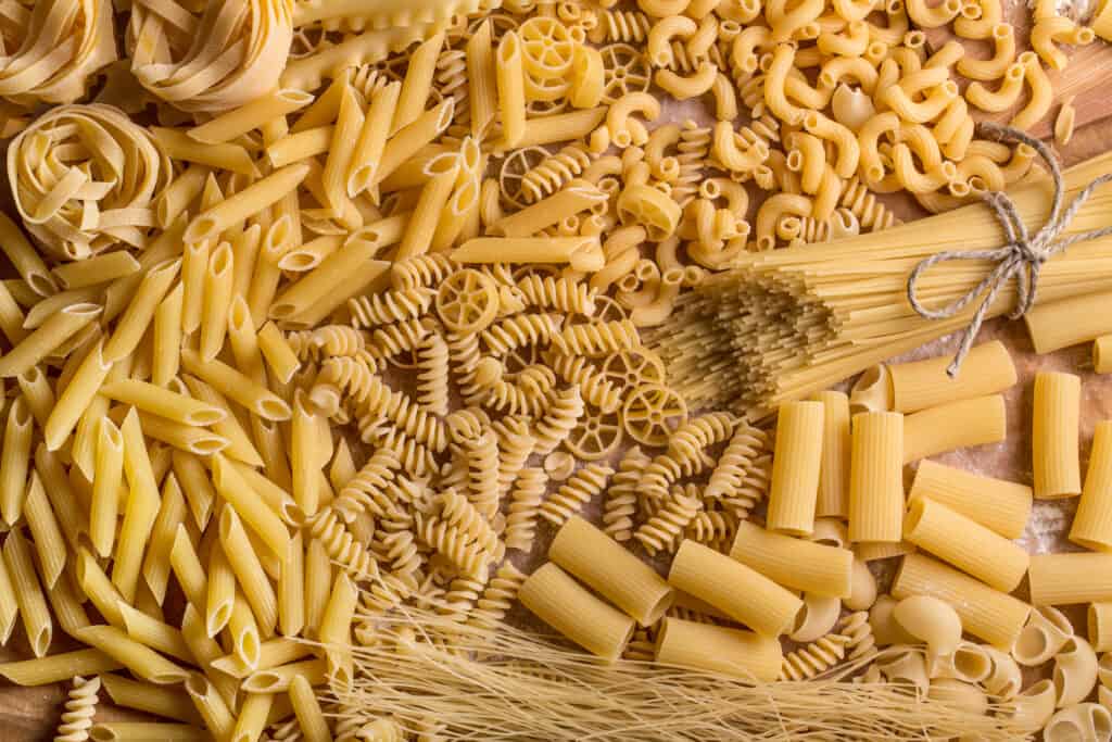 Variety of types and shapes of dry pasta.