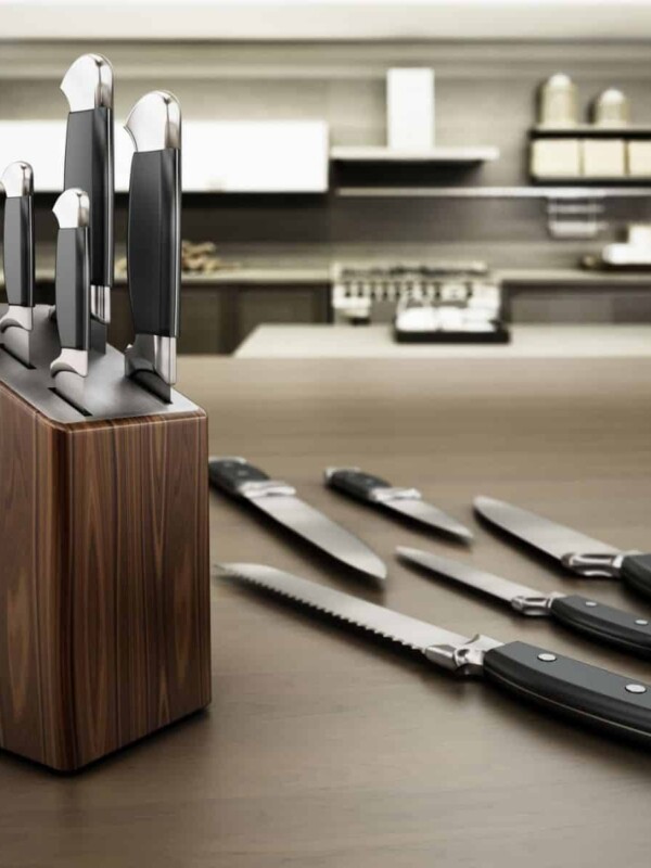 Set of different types of kitchen knives standing on the table.