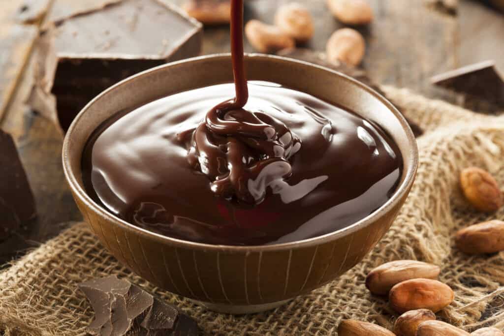 A delicious bowl of melted chocolate ready to be served with your desserts.