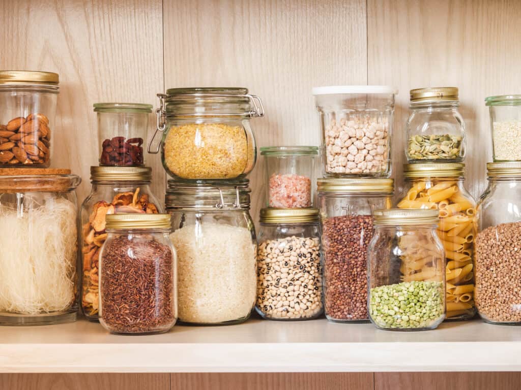 Shelf in the kitchen pantry with various cereals and seeds