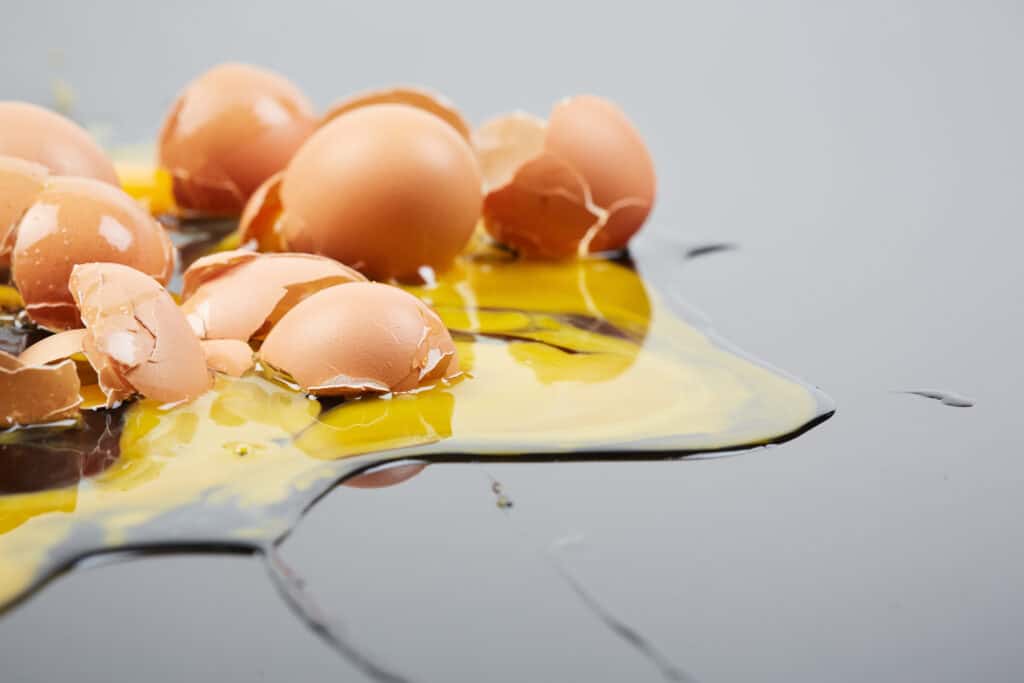 Creating a clean and safe kitchen is a vital step toward a healthy household. a spilled, raw, broken egg on a kitchen counter because of a messy workspace.
