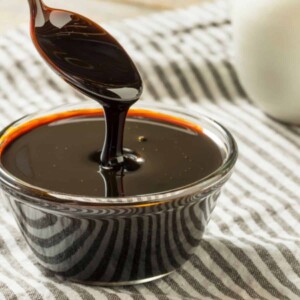 Homemade organic black cane sugar molasses in a glass small bowl