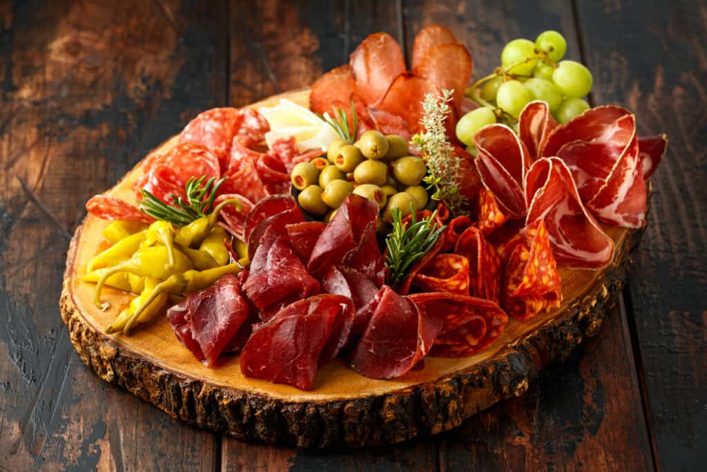 This picture says it all showing the best deli meats to serve on a charcuterie board.