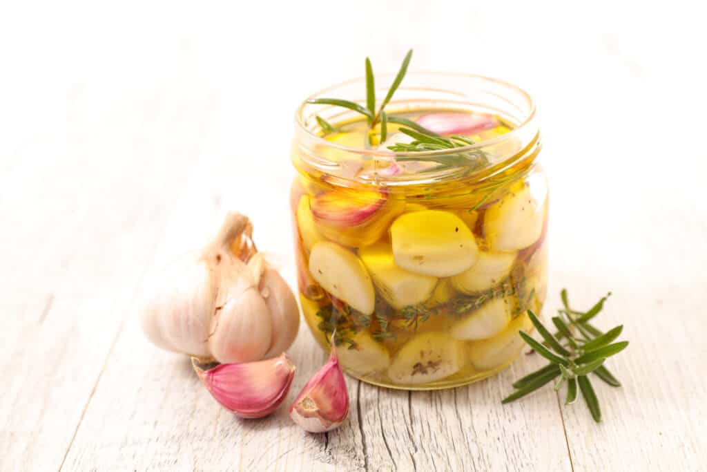 Garlic with oil and rosemary is such a staple ingredient in the kitchen. Knowing the best ways to prep raw garlic for future use is ideal.