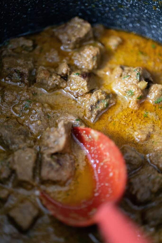 mini beef chunks being cooked in ghee with seasonings