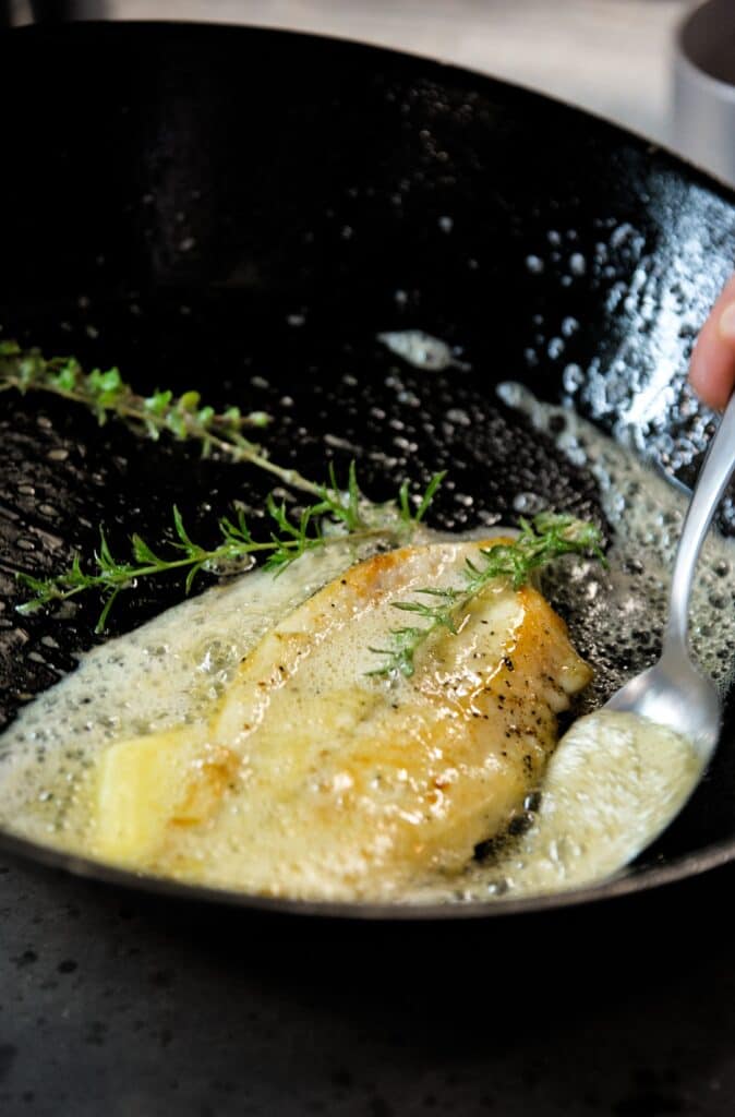 ghee in a pan with fresh rosemary to enhance flavors of certain proteins like meat or chicken